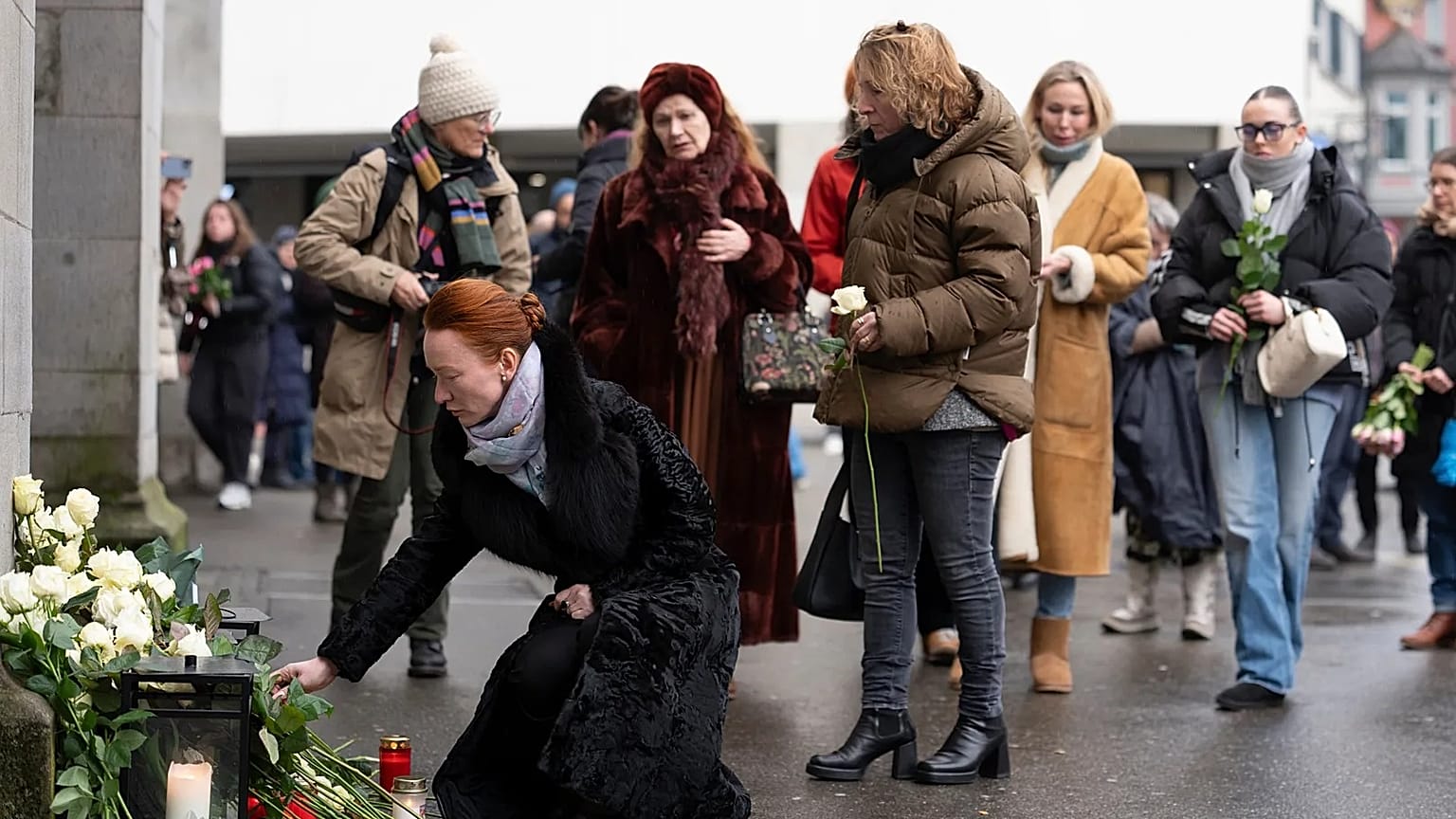 People lay flowers in tribute to the victims of the deadly bar fire in Zurich, 9 January, 2026
