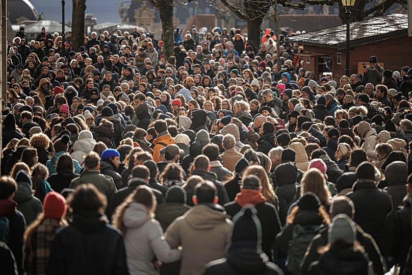 People gather for a minute of silence on the national day of mourning at Lausanne Cathedral, 9 January, 2026