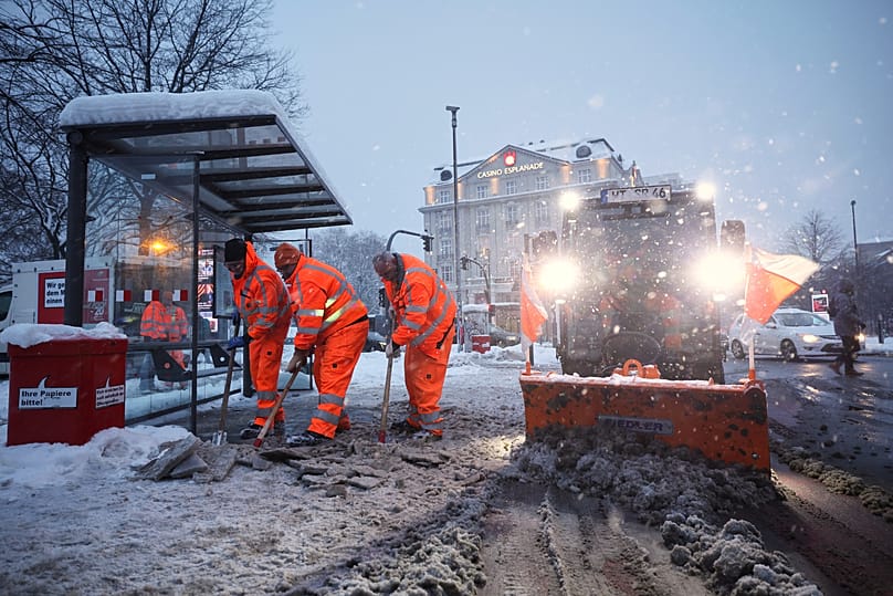 Hamburg municipal workers clear ice and snow from a bus stop at Stephansplatz, 9 January, 2026