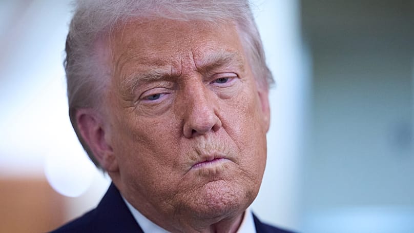 President Donald Trump speaks with reporters aboard Air Force One after leaving the World Economic Forum in Davos for Washington, Thursday, Jan. 22, 2026.