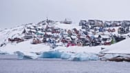 Coloured houses covered by snow are seen from the sea in Nuuk, Greenland, on March 6, 2025. 