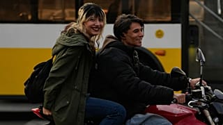 A man and a woman ride a motorbike in northern Tehran, Iran