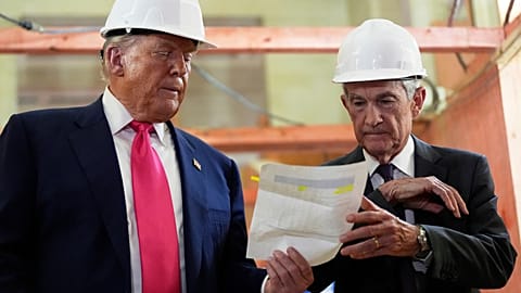 FILE. Fed Reserve Chairman Jerome Powell and President Donald Trump look over a document of cost figures during a visit to the Federal Reserve. Washington. 24 July 2025. 