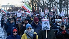 Protesters participate in a demonstration in front of the Brandenburg Gate in Berlin, Germany, in support of the nationwide protests in Iran against, Sunday, January 11, 2026