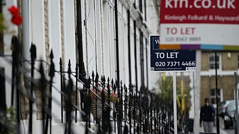 FILE. To Let signs stand next to a properties in west London. 2 Aug. 2016.