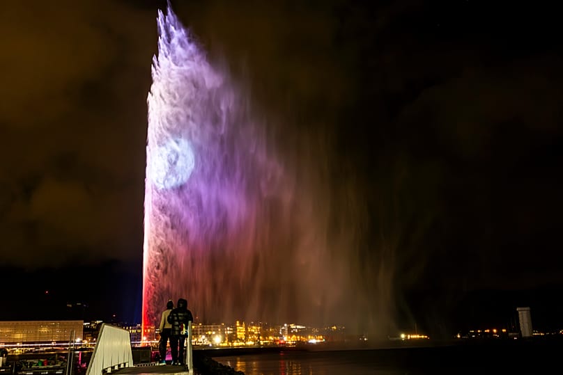 The water fountain "Le Jet d'Eau" is illuminated in the colours of the Canton of Valais on the national day of mourning in Geneva, 9 January, 2026