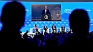 FILE: People follow a virtual speech of US President Donald Trump at the Annual Meeting of World Economic Forum in Davos, 23 January 2025