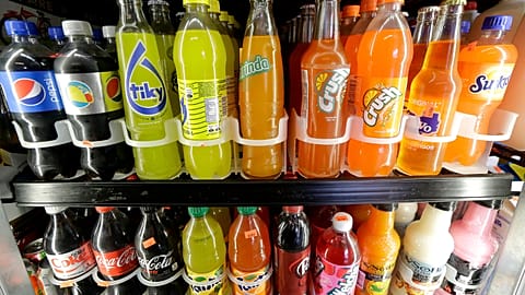 File - Soft drink and soda bottles are displayed in a refrigerator at El Ahorro market in San Francisco