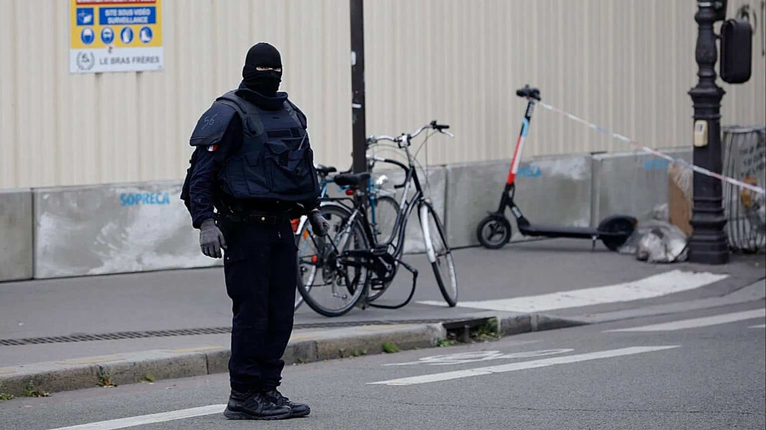 FILE: A masked police officer stands next to a police tape after an incident in Paris, 3 October 2019