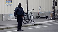 FILE: A masked police officer stands next to a police tape after an incident in Paris, 3 October 2019