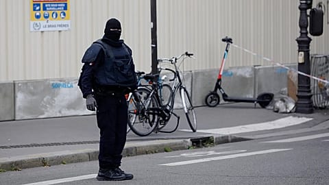 FILE: A masked police officer stands next to a police tape after an incident in Paris, 3 October 2019
