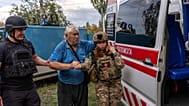 FILE: Police officers help Mykola Puzyk in Sloviansk, Donetsk region, Tuesday, Sept.9, 2025.