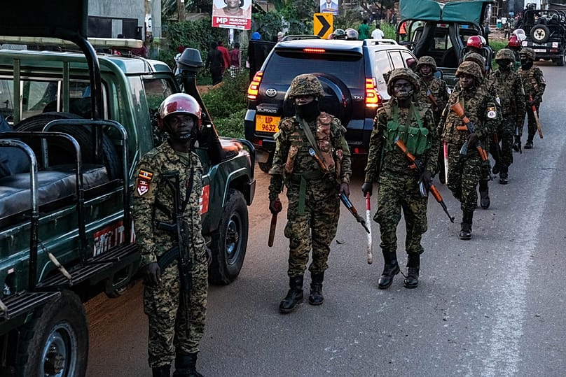 Ugandan security forces patrol a street during a campaign rally for opposition presidential candidate Bobi Wine, ahead of elections, Mukono, Uganda, Friday, Jan. 9, 2026