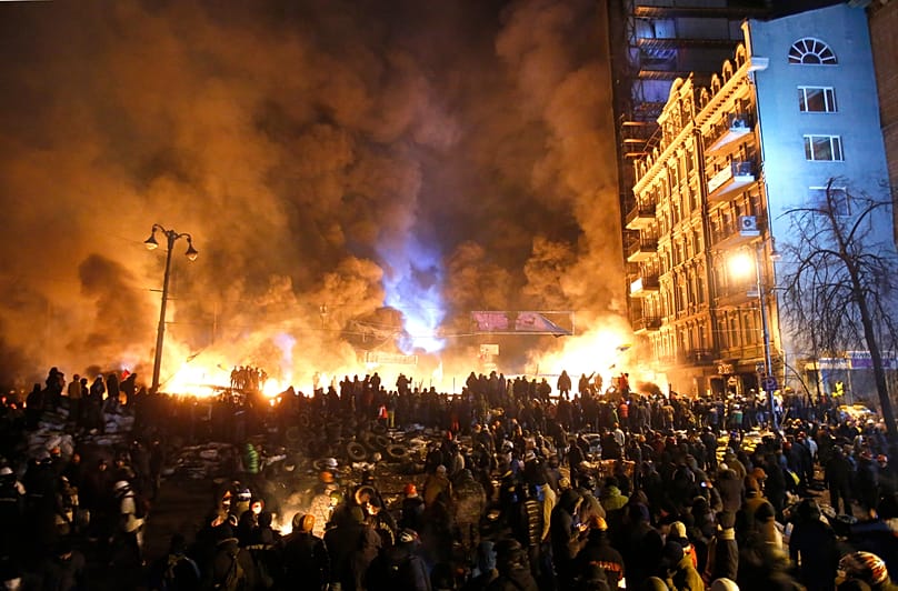 Smoke and fireballs rise during clashes between protesters and police in central Kyiv, 25 January, 2014