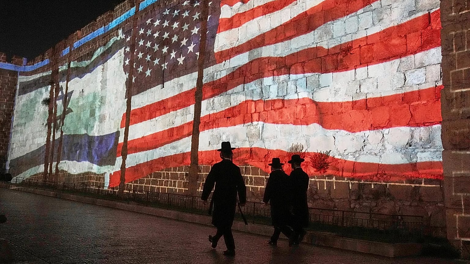 An image of the US and Israeli flags is projected on the walls of Jerusalem's Old City, 22 July, 2025