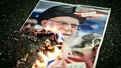 FILE: A buring image of the Ayatollah Ali Khamenei is seen during rally in support of the nationwide mass demonstrations in Iran, in Zurich, 13 January 2026