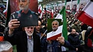 Two men hold up posters of the late commander of Iran's Revolutionary Guard expeditionary Quds Force, Gen. Qassem Soleimani, who was killed in a U.S. drone attack in 2020