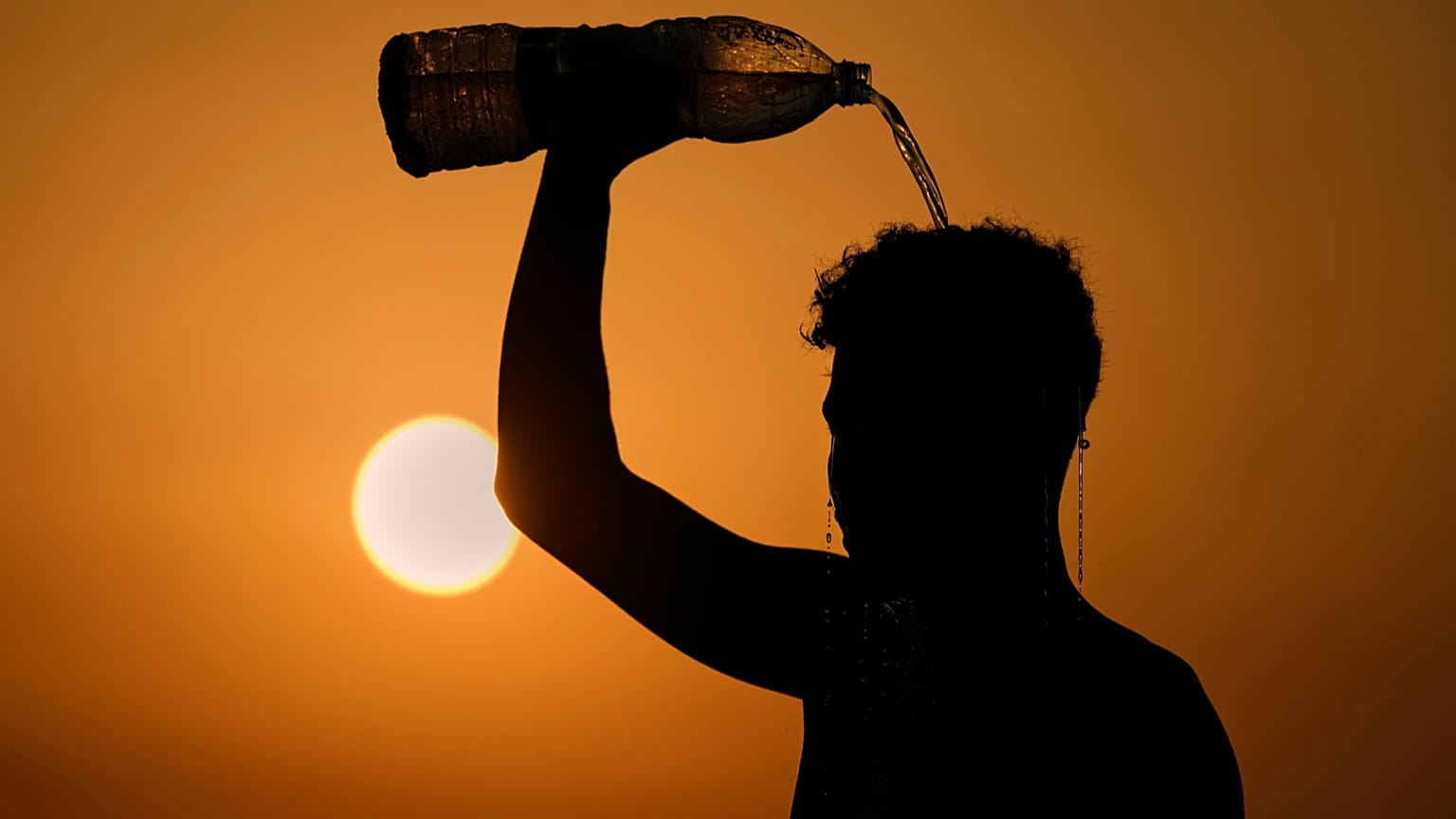 A man rinses with water after playing beach footvolley on the Ramlet al-Baida public beach in Beirut, Lebanon, Aug. 14, 2025, on a sweltering hot day. 
