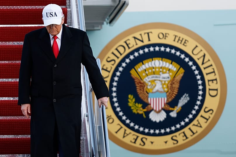 US President Donald Trump walks down the stairs of Air Force One upon his arrival at Joint Base Andrews, 13 January, 2026