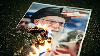 A burning image of the Ayatollah Ali Khamenei is seen during rally in Zurich, 13 January, 2026 