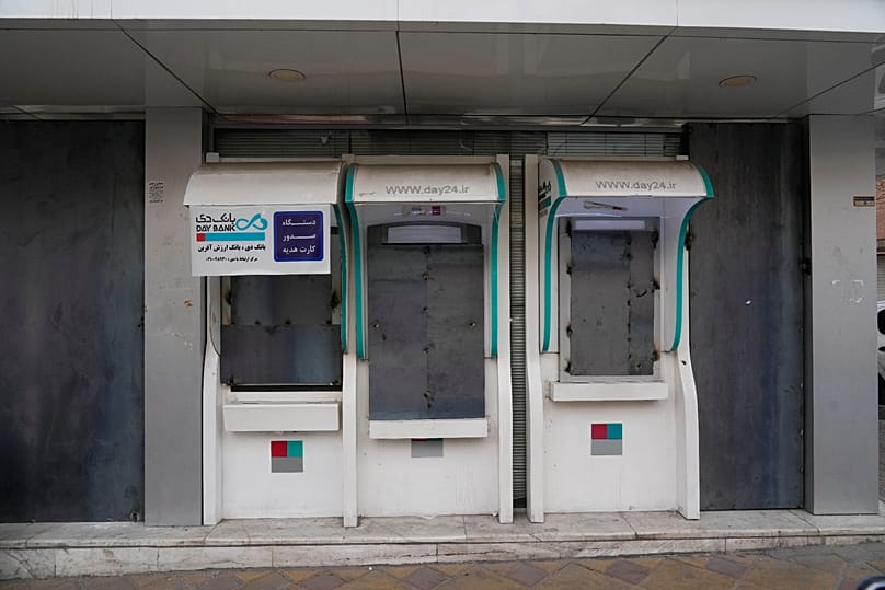 A bank's ATMs and windows are covered with metal sheets after anti-government protests in Tehran, 14 January, 2026