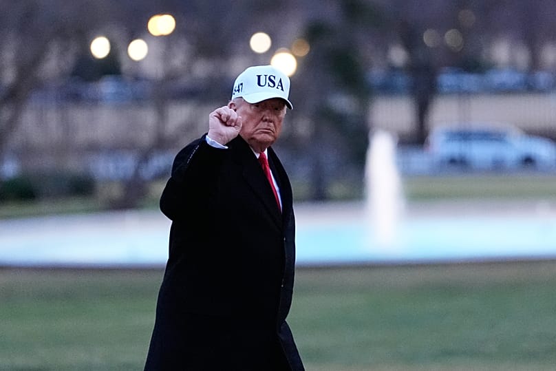 US President Donald Trump gestures as he walks from Marine One after arriving at the White House, 13 January, 2026