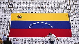 Students lay out photos of people they consider political prisoners at the Central University of Venezuela in Caracas, 13 January, 2026