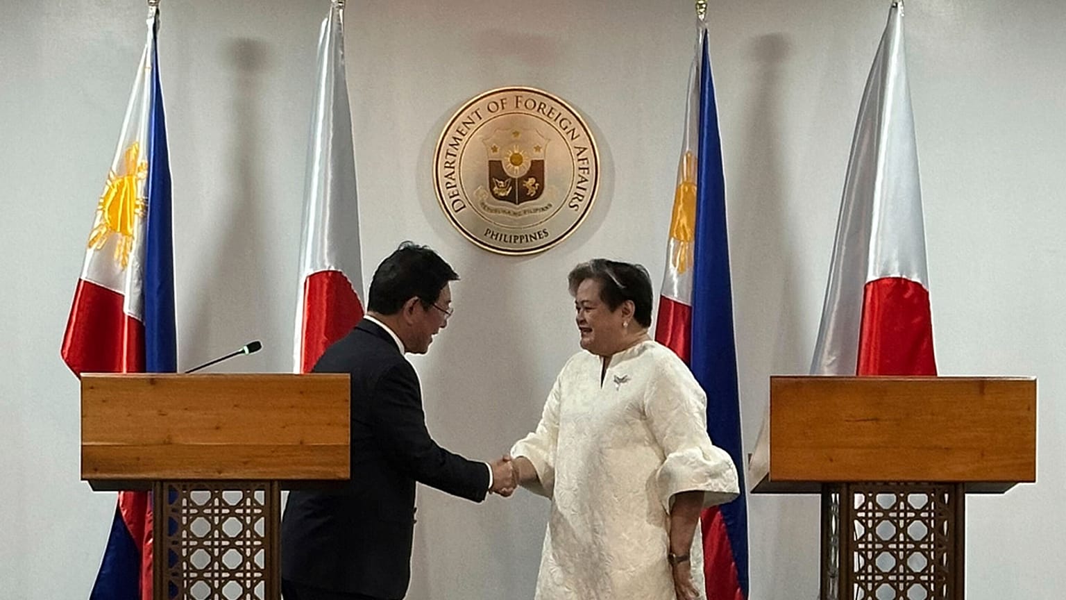 Japanese Foreign Minister Toshimitsu Motegi, left, and Philippine Foreign Secretary Theresa Lazaro shake hands in Manila, Thursday, Jan. 15, 2026. (AP Photo/Joeal Calupitan)