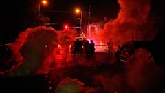 Tränengas liegt in der Luft. Bundesermittler verlassen nach einer Schießerei am Mittwoch, 14. Januar 2026, den Tatort in Minneapolis.