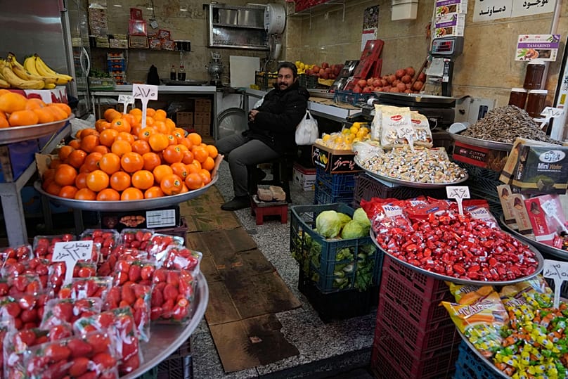 A fruit seller waits for customer at Tehran's historic Grand Bazaar, 20 January, 2026