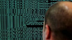 A solider watches code lines on his computer at the International Cybersecurity forum in Lille, 23 January, 2018