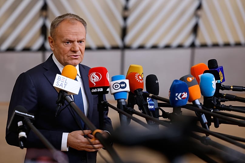 Poland's Prime Minister Donald Tusk speaks with the media as he arrives for the EU Summit in Brussels, 18 December, 2025
