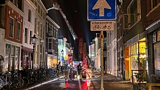 Firefighters extinguish the fire at the scene of an explosion in Utrecht, Netherlands