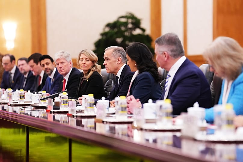 Canada's Prime Minister Mark Carney, fourth right, alongside Industry Minister Melanie Joly, fifth right, and Foreign Affairs Minister Anita Anand, third right, meets with Xi.