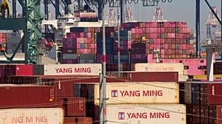 FILE. Containers with a Taiwanese container shipping company are stacked up at the Port of Los Angeles, 9 April 2025