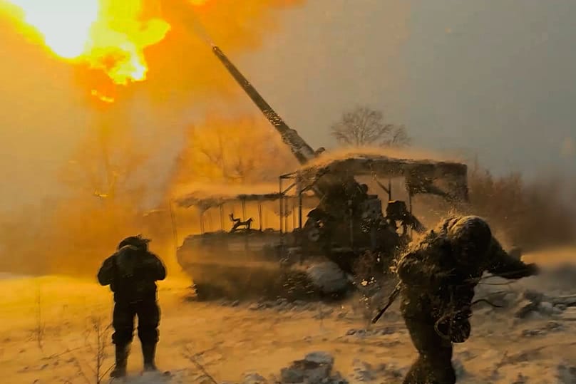 Russian soldiers fire a Pion self-propelled 203 mm gun towards Ukrainian positions in Ukraine on Tuesday, Jan. 13, 2026