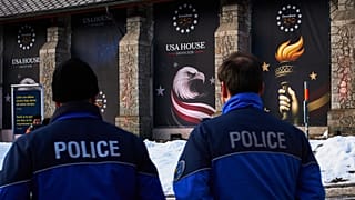 Police officers walk in front of the USA house ahead of the Annual Meeting of the World Economy Forum in Davos, 17 January 2026