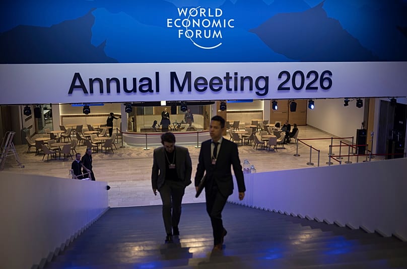 Two men walk up the stairs at the Congress Center where the Annnual Meeting of the World Economy Forum takes place in Davos, 18 January 2026