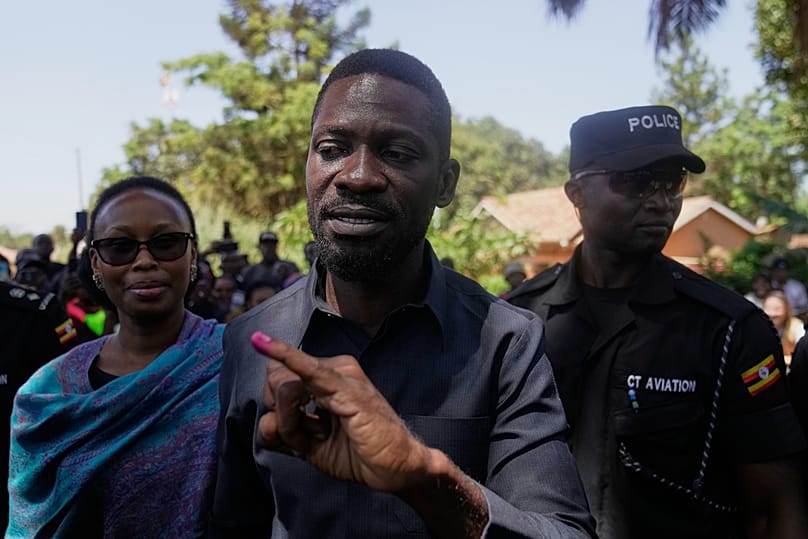 Uganda opposition presidential candidate Bobi Wine shows the ink on his finger after casting his vote, during the presidential election in Kampala, Uganda, Jan. 15, 2025