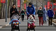 Women walk with their toddlers as residents visit a public park in Beijing.