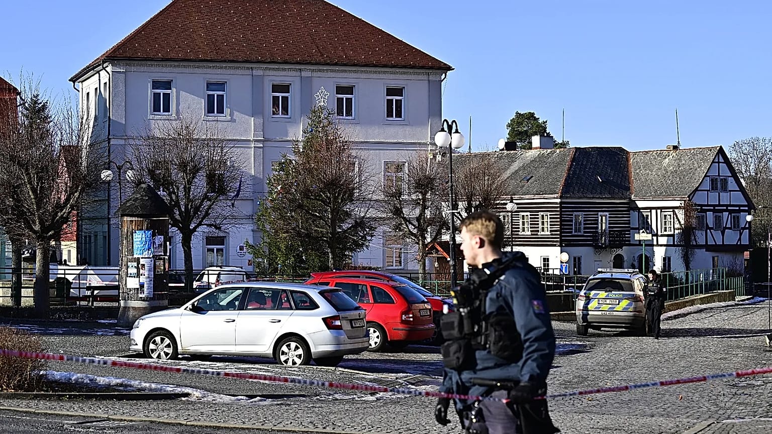 A police officer stands in front of the town hall in Chřibská, 19 January, 2026
