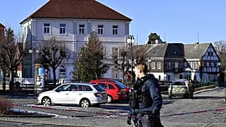 A police officer stands in front of the town hall in Chřibská, 19 January, 2026