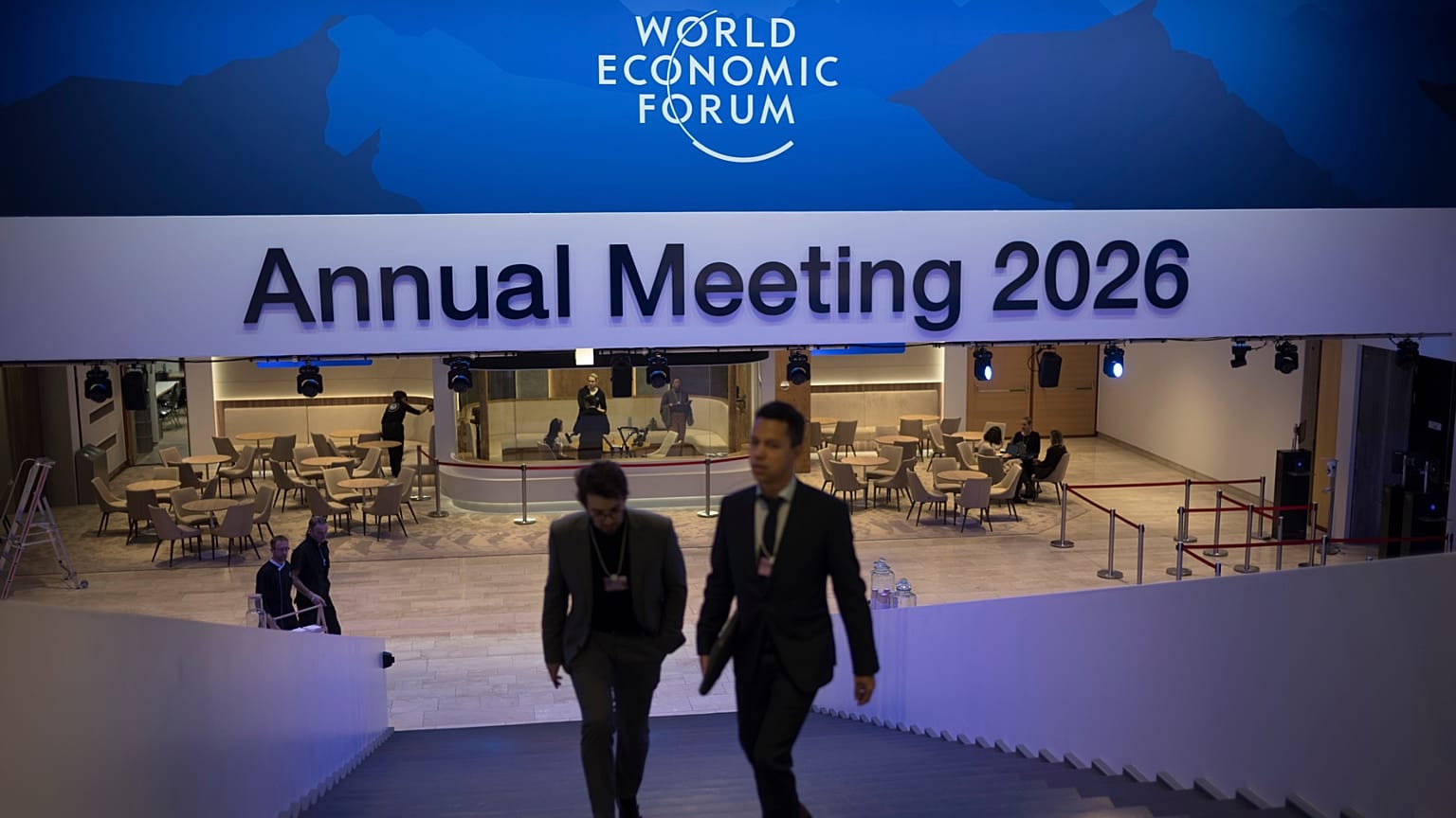 Two men walk up the stairs at the Congress Center where the Annnual Meeting of the World Economy Forum takes place in Davos, Switzerland, Sunday, Jan. 18, 2026