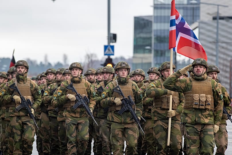 Norwegian soldiers march during a military parade ceremony marking the 105th anniversary of the Lithuanian military in Vilnius, 25 November, 2023