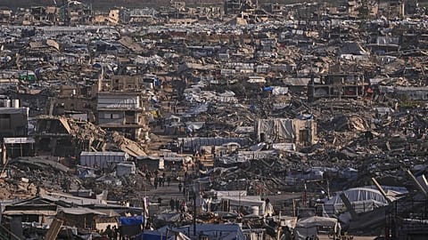 Makeshift tents shelter displaced Palestinians stand among buildings destroyed by Israeli air and ground operations in Gaza City, 15 January, 2026