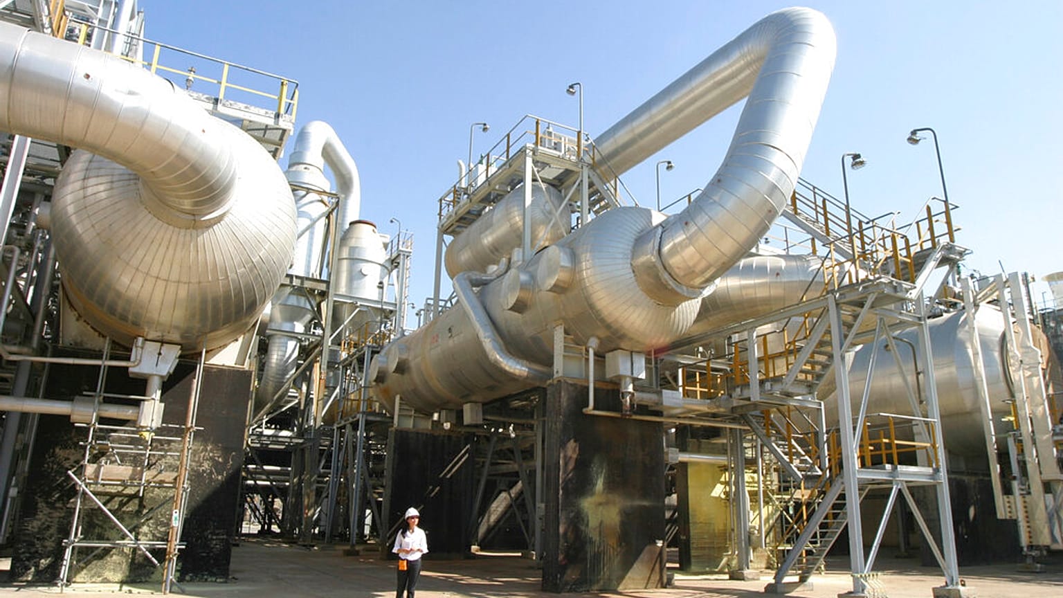 FILE - A worker strolls along Tengiz oil refinery utilities in Kazakhstan. 30 August 2004. 