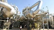 FILE - A worker strolls along Tengiz oil refinery utilities in Kazakhstan. 30 August 2004. 