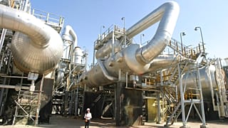 FILE - A worker strolls along Tengiz oil refinery utilities in Kazakhstan. 30 August 2004. 