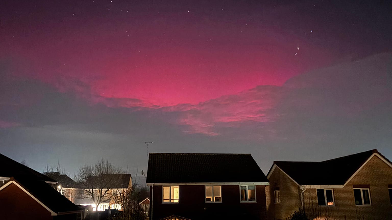 A aurora boreal ilumina a cobertura de nuvens sobre Rushmere St. Andrew, Ipswich, Inglaterra, segunda-feira, 19 de janeiro de 2026. (Joe Pickover/PA via AP)
