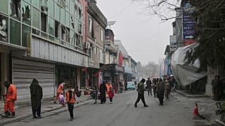 Workers clean the scene as Taliban police secure the area after an explosion at a Chinese restaurant in Kabul, 20 January, 2026